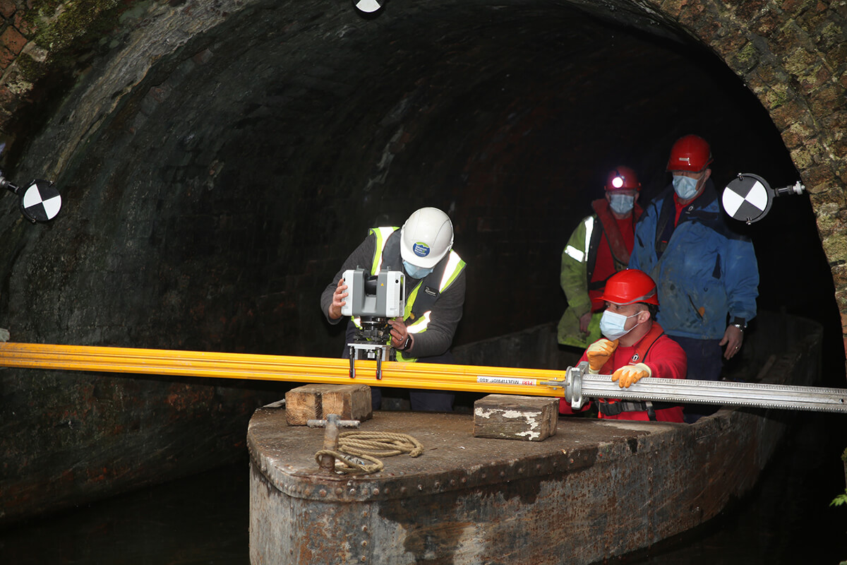 The team mount the RTC360 to the support beam at the entrance to the second stage of the tunnel